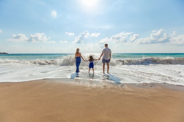 Reisegutschein verschenken: Familie am Strand als Symbol für gemeinsame Auszeit